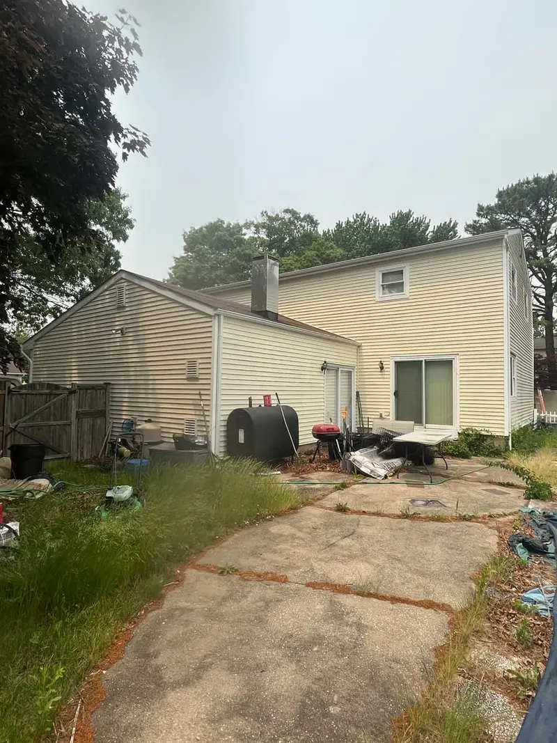 Back of a two story house with an outdoor oil tank, Coram, NY